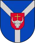 A coat of arms depicting a grey bull's head with a golden cross protruding from the top all on a red crest on a blue background
