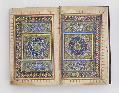 Book opened to show double-page spread of colourful geometric patterns