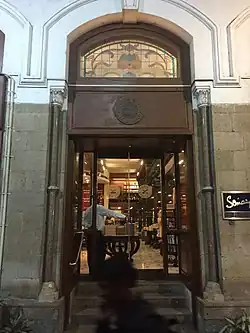 Profile of stone face on mountainside, with 3 workers.