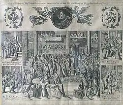 A bishop crowns a kneeling man in a large church filled with dozens of men