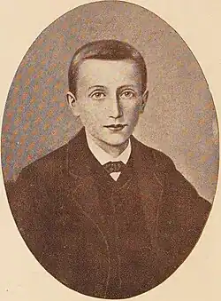 Oval portrait of Savio wearing a suit