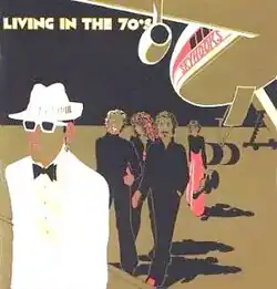 A cartoonish depiction of musicians on the tarmac beneath an aeroplane. The album's title is in white on black, using all caps, at top left. The group's name is in red on white on the plane's side.