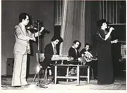 Hayedeh, Loghman Adhami, and other musicians at a concert, in the 1970s