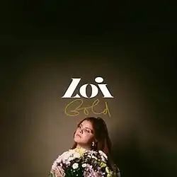 A woman holding a bouquet of flowers standing in front of a dark background.