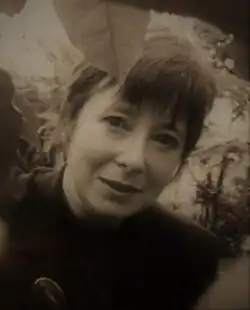 Black and white portrait photograph of Lorna Young in a garden