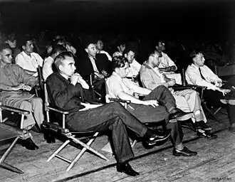 A crowd seated in folding chairs