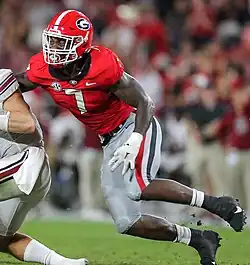 Walker playing on a football field in college