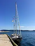 A sailboat docked at a pier in The Front