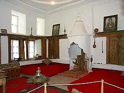 Two large beds near the floor, with a fireplace between them