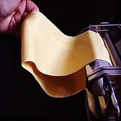 Dough is rolled into thin sheets.