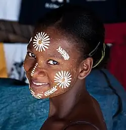 Image 4Malagasy girl in Nosy Be wearing masonjoany, an endemic decorative and protective paste made from ground wood (from Culture of Madagascar)