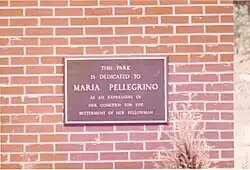 Maria Pellegrino dedication plaque at park entrance.