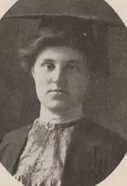 A young white woman wearing an academic mortarboard cap