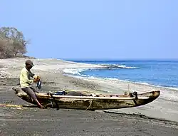 A fisher and fishing canoe at Maubara in 2006