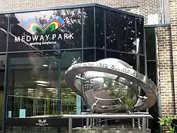 A stainless steel sculpture, Olympic Countdown Clock, beside the entrance to the sports centre[75]