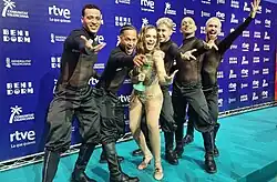 Melody and her dancers (left to right: Bolivar, Arango, Busarov, Urquiaga, and Montojo) after winning Benidorm Fest holding the trophy.