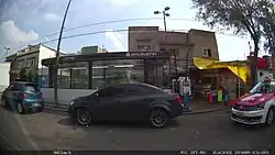 Image of a station entrance behind a car.