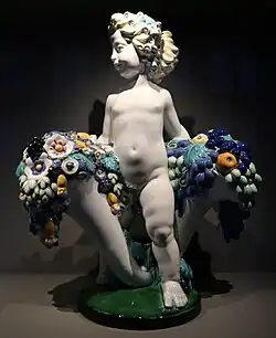 Austrian Art Nouveau – Putto with two cornucopias with floral cascades, by Michael Powolny, designed in c. 1907, produced in 1912, ceramic, Kunstgewerbemuseum Berlin, Berlin, Germany[68]