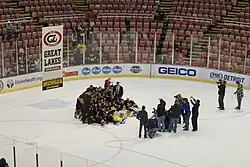 Michigan posing with the GLI banner after winning the 2015 tournament