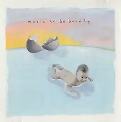 A baby, which has apparently just emerged from a large egg