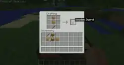 The player attempting to make a wooden sword by placing the required materials into the crafting grid, a 3x3 block of item spaces hovering over the standard inventory, which is filled with other items.