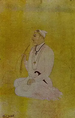 A color portrait of a turbaned man smoking a pipe