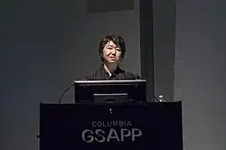 Kaijima giving a lecture in front of a podium