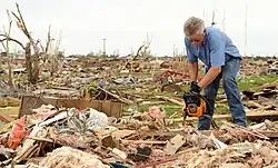 A Moore, Oklahoma resident begins cleaning debris from the wreckage of his home in the aftermath of the 2013 tornado.