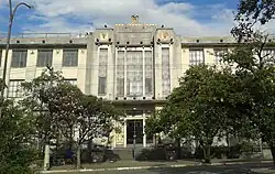 Front of three-story building against a blue sky