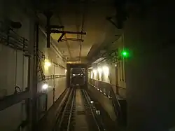 View of the underground tunnel with the overhead lines powering the train