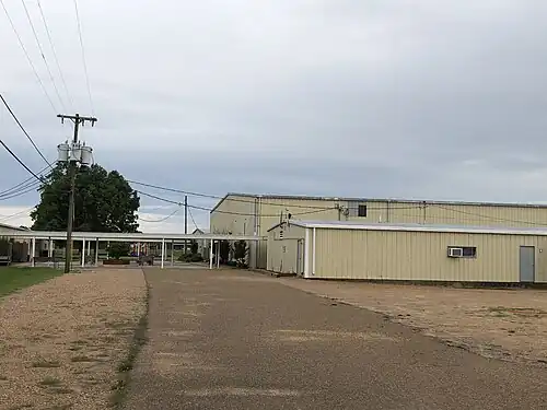 West of the main school building, the forward most building in the image is the field house, with the gym and cafeteria behind, respectively