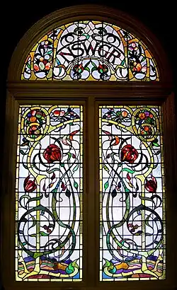 One of a series of large windows of Art Nouveau design in Favrile and cathedral glass, with the state's floral emblem, the waratah, Sydney Central Station, NSW, Australia. Despite the complexity, the execution was classed as "leadlighting".