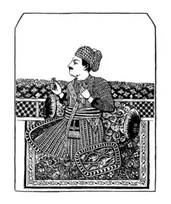 A black and white portrait of a mustached man wearing a turban/crown