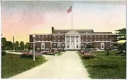 Four-story brick building with formal driveway