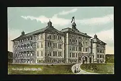 Architect's sketch of General Hospital 3, a four-story building with balconies covering one face and an arched entrance at the end of the driveway.
