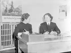 A journalist (left) interviewing a woman in uniform (right) from the Women's Royal Canadian Naval Service, 1943
