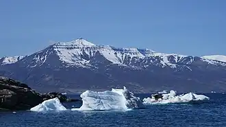 Qilertiinguit Kangilequtaa (2,070&nbsp;m (6,791&nbsp;ft))[2] seen from Uummannaq across the main arm of Uummannaq Fjord