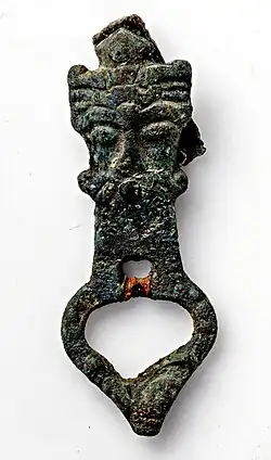 Colour photograph of a bronze buckle