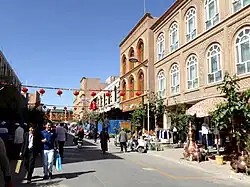 Street scene in a renovated part of Kashgar Old City. The renovated homes are reinforced with mud bricks and are of a reddish brown colour.