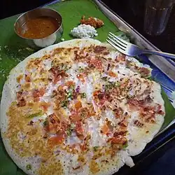 Uthappam or utthapa, a version with onion, chilli, and tomato