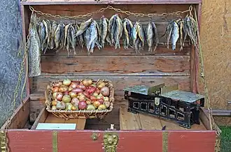 Onions and dried fish for sale on a farmer's roadside stand.