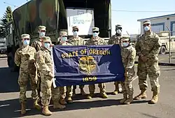 Oregon Guardsmen with the state flag.