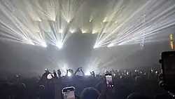 Intense lighting effects during a Osamason show in 2025. The image displays bright lights that add a silhouette effect to the performing artist.