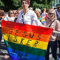 Participant with a Jesus inscription on the rainbow flag during the 2015 Pride Parade.