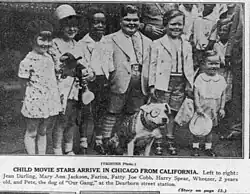 A grainy black-and white photo of child actors and a dog