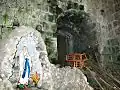 Our Lady of Lourdes Grotto at the foot of the bell tower