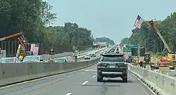 A construction zone, with two American flags