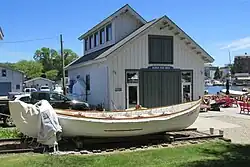 a U.S. Coast Guard rescue dinghy in front of the Padnos Boat Shed
