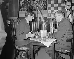Donner and Euwe talking after their game, still sitting at the board