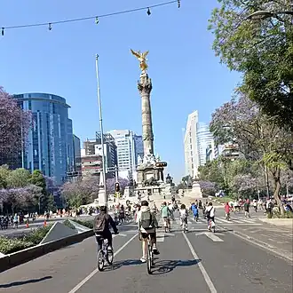 Bicyclists on road in front of landmark victory column
